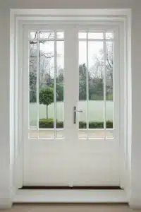White aluminium bifold doors onto a garden in Crosby